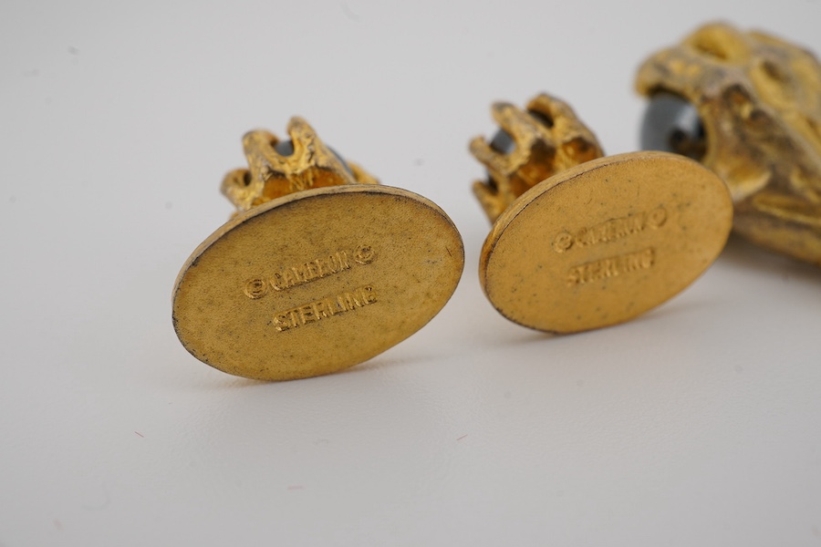 A modern gilt sterling and hematite set six piece dress stud set, modelled as a hand grasping a sphere, comprising a pair of cuff links 30mm and four studs. Condition - poor to fair